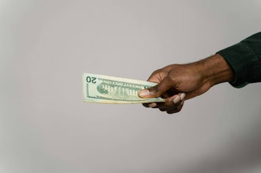 Hand holding cash, symbolizing different types of personal loans.