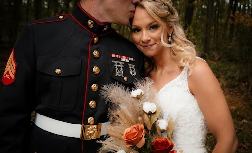 Man in military uniform standing with woman in a wedding dress