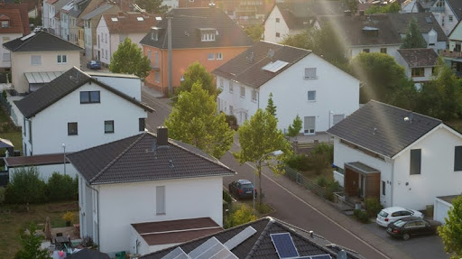 Aerial view of suburban homes with solar panels on rooftops.