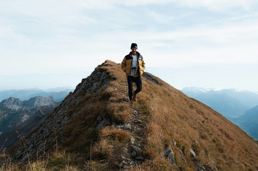 Man standing alone on a rocky mountain summit