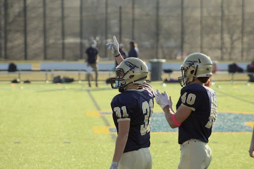 Football player leading teammates across the field