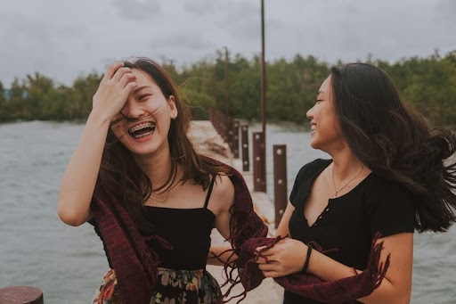 Two women laughing and enjoying a lighthearted moment together.