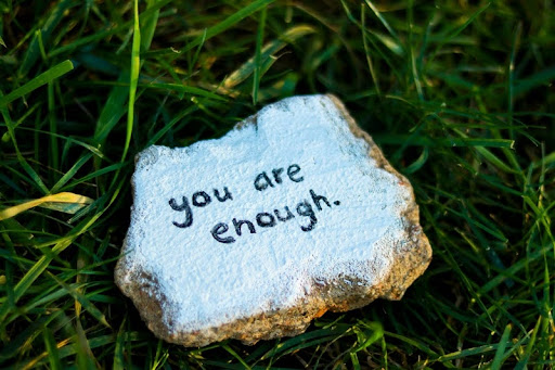 Rock with the words “you are enough” written on it.