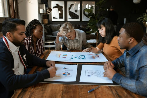 People in a team meeting discussing ideas around a conference table