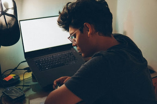 Man sitting at a desk using a laptop