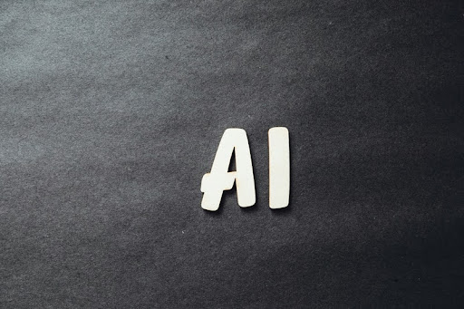 White "AI" text on a black textured background