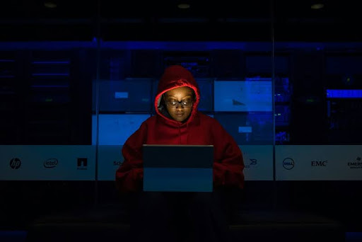 Woman using a laptop in a dark room