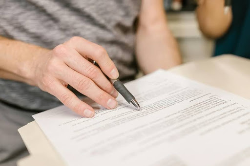 Person reviewing a printed document at a table