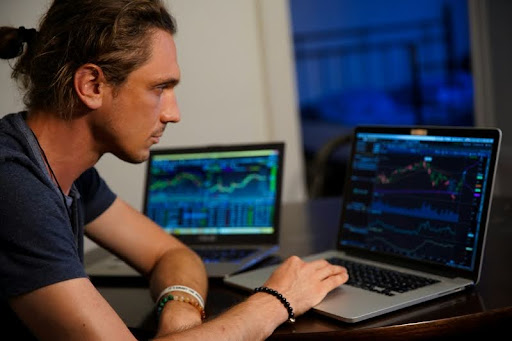 Man researching investments on a MacBook Pro