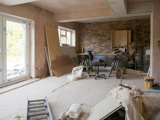 House under renovation with construction materials and tools visible