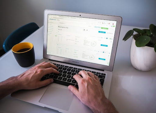 Man working on email automation at a laptop on a white desk