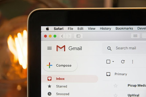 Black laptop displaying Gmail logo on the screen