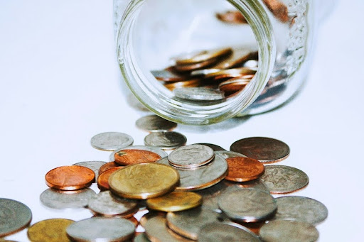 Clear glass jar filled with coins.