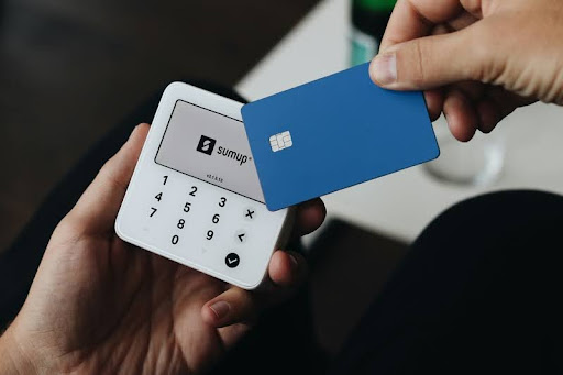 Person holding a credit card to build credit