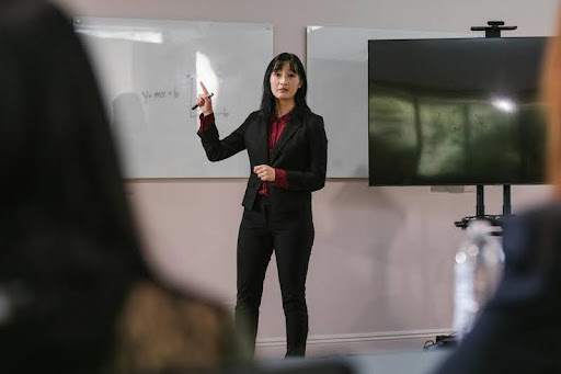 Female professional giving a presentation to a group in a meeting room