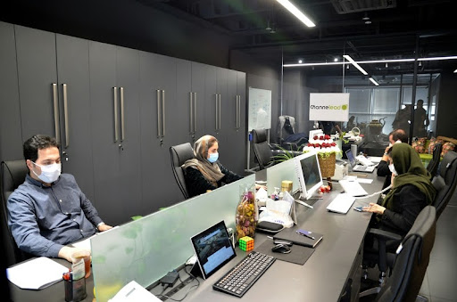 Employees working independently at desks in a modern office setting.