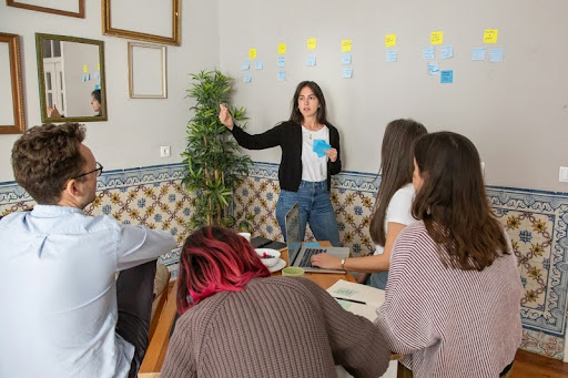 Woman leading a team meeting in a modern office setting.
