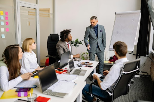 Office team engaged in a collaborative meeting around a conference table.
