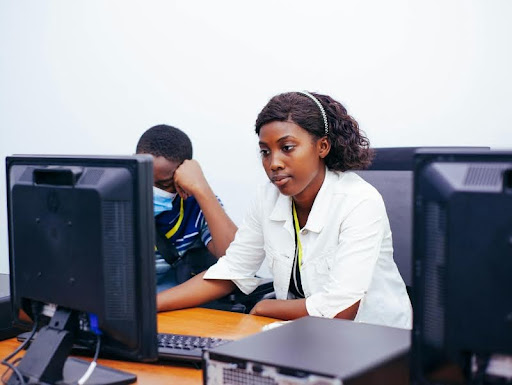 Woman working at desk in modern office, looking focused and relaxed
