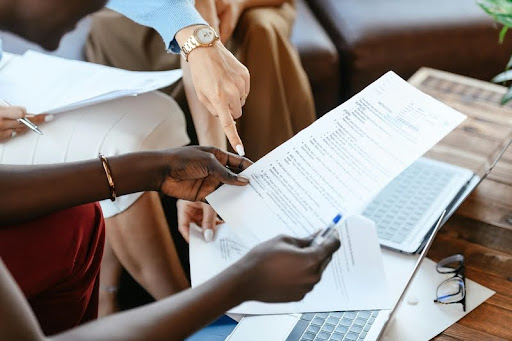 Diverse group of professional women reviewing a document together