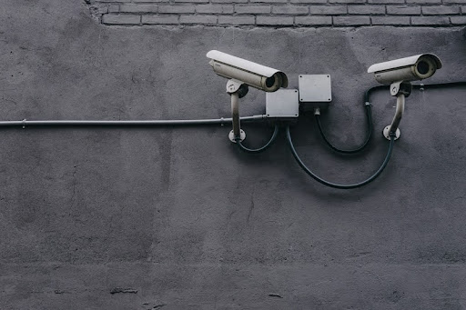 Two bullet surveillance cameras mounted on a wall