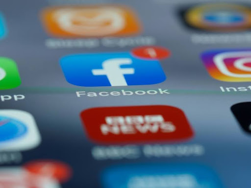 Close-up of a smartphone screen displaying various social media apps