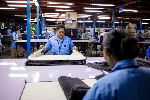 Factory workers assembling materials on a production line