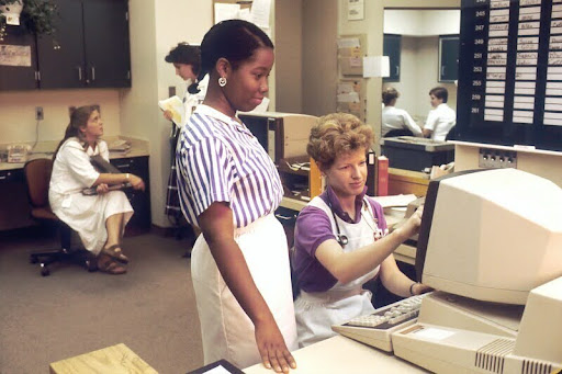 Young man and woman collaborating while looking at a computer screen.