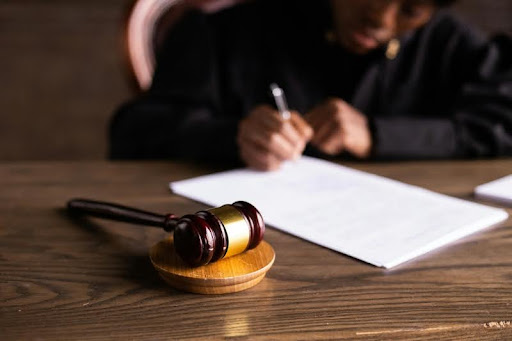 Judge signing legal documents at a desk