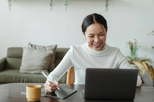 Woman working remotely at home on a laptop