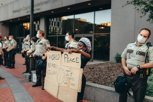 Woman holding protest sign against workplace discrimination