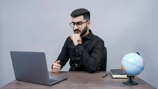 Employee focused on laptop screen at desk