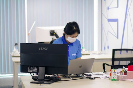 Woman working on a laptop at a desk