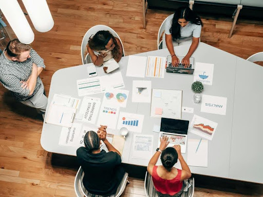 Colleagues in an office discussing a project around a table