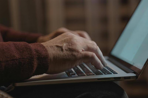 Person typing on a laptop at a desk