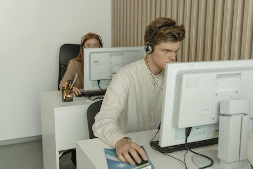 Man and woman working together at a desk in a modern office.