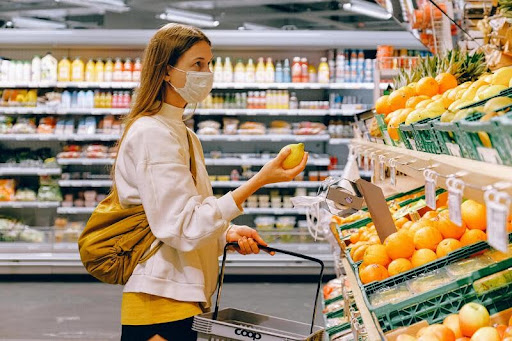 Woman selecting fresh fruits at a grocery store