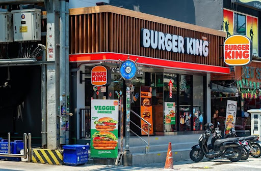 Modern restaurant exterior with clear signage and outdoor seating