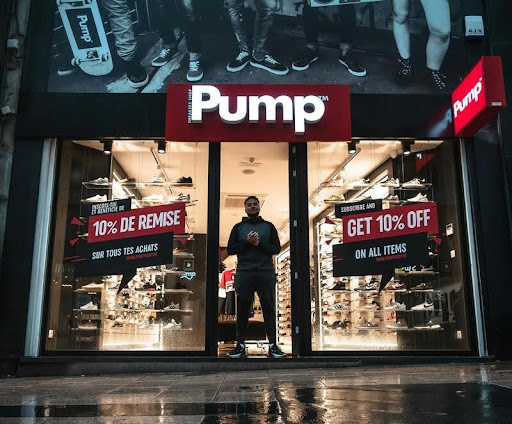 Man standing at the entrance of a pump shop