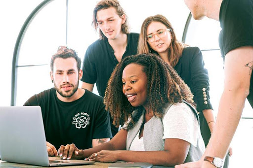 Woman presenting a marketing strategy to colleagues in an office meeting.