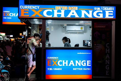 Man standing outside a currency exchange shop