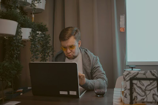 Man using laptop to explore DeFi passive income options