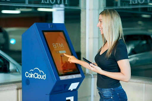 Woman using an ATM machine outdoors