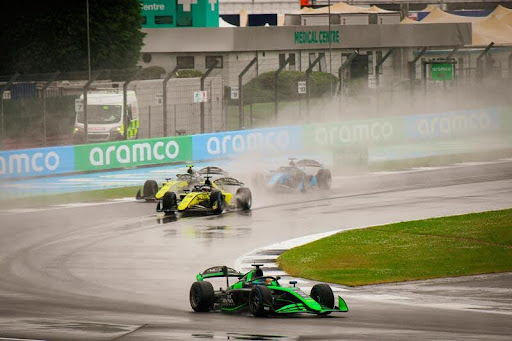 Formula One cars racing at high speed on a professional circuit