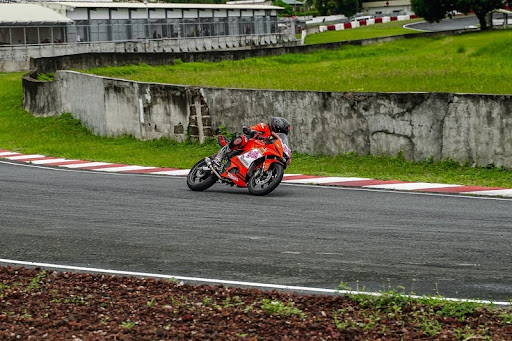 Motorcycle racer leaning into a turn on a track