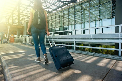 Woman traveler holding a bag, preparing for a medical trip.
