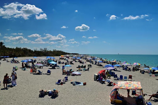 Sunny beach with blue sky and gentle waves in Florida