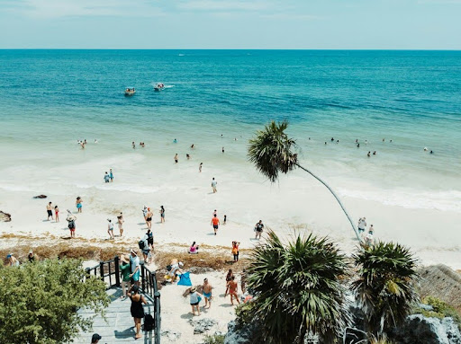 Aerial view of a Florida beach with people sunbathing and walking along the shoreline