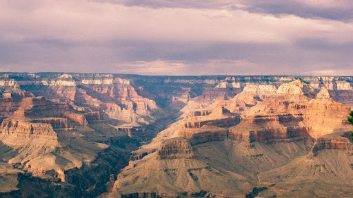 View of the Grand Canyon with layered red rock formations under a clear blue sky