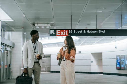 Two business travelers talking at an airport lounge.